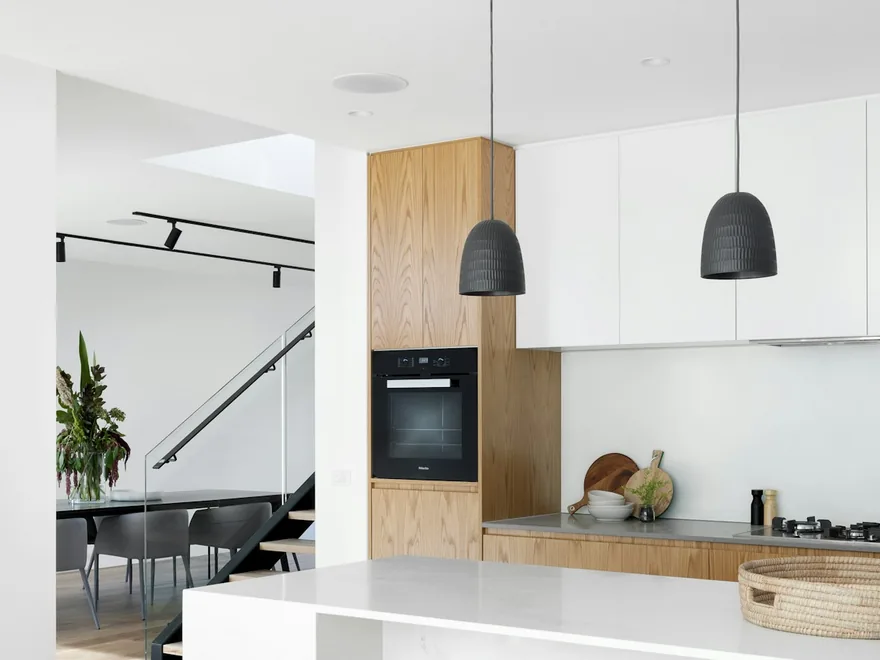 A clean, bright home kitchen with clear counters.