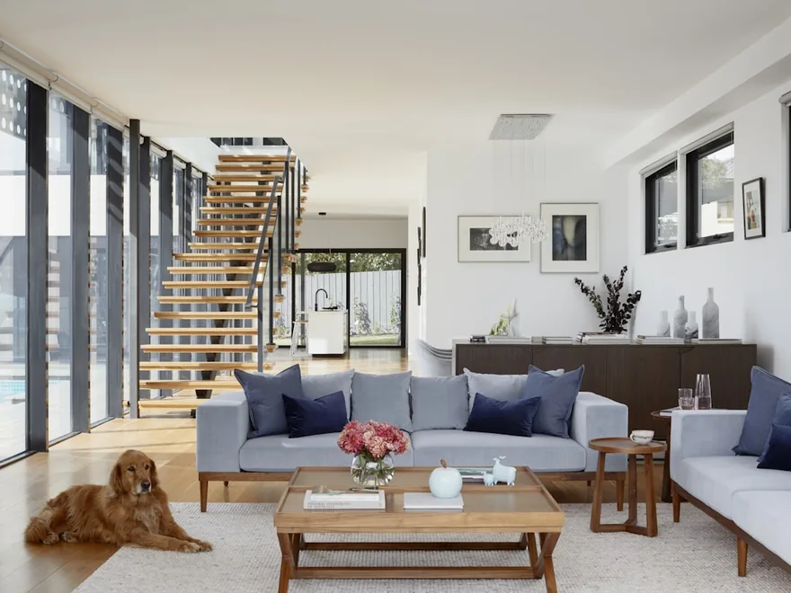An empty, freshly cleaned living room with large windows.