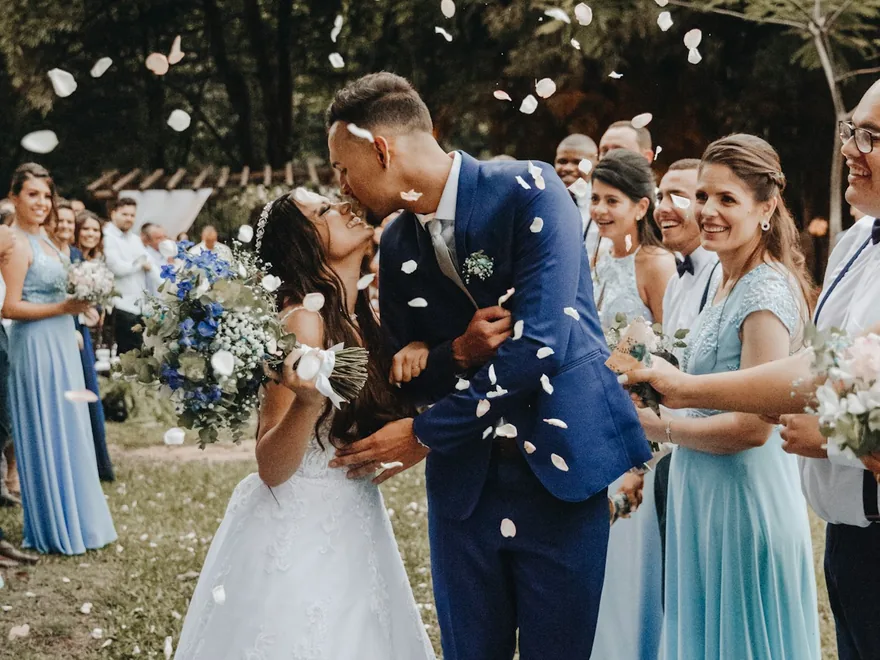 A wedding party gathered outdoors after the ceremony.