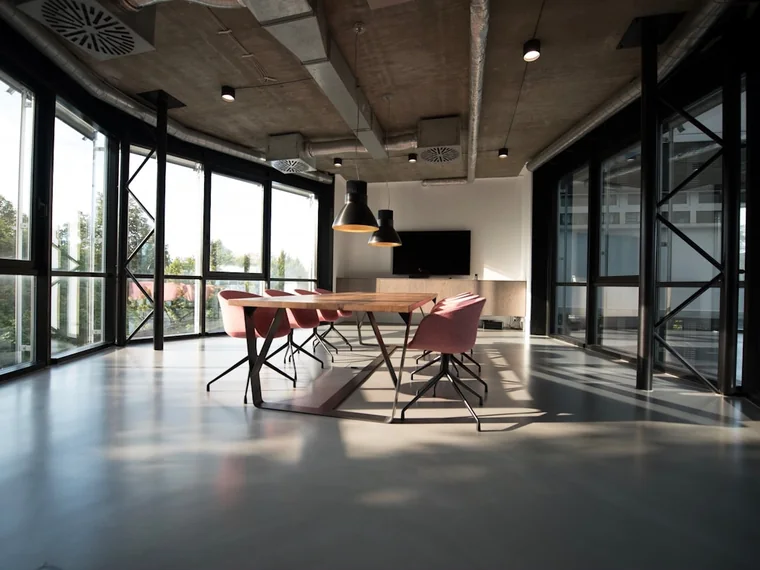 A bright office meeting room with clear surfaces after a commercial clean.